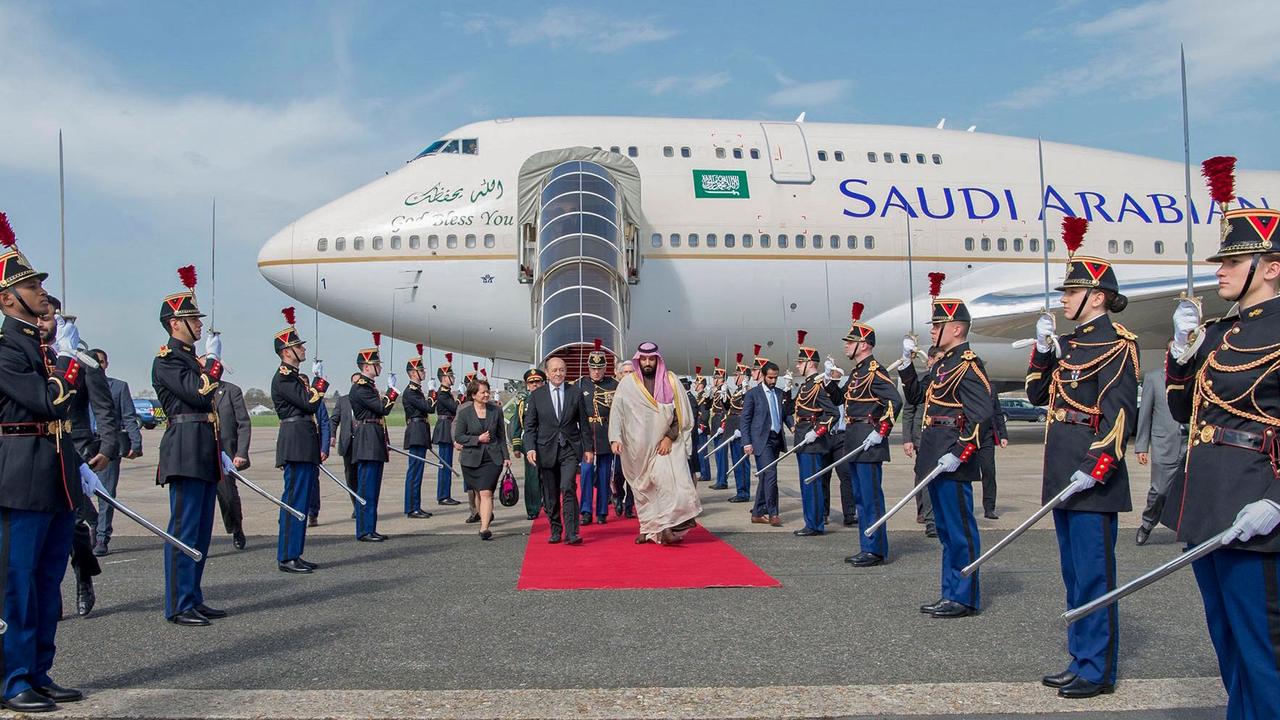 CORRECTION - French Foreign Affairs Minister Jean-Yves Le Drian (C-L) welcomes Saudi Arabia's crown prince Prince Mohammed bin Salman (C-R) at Le Bourget airport, north of Paris, on April 8, 2018. Saudi Arabia's crown prince Prince Mohammed bin Salman arrived in France on April 8, for the next leg of a global tour aimed at reshaping his kingdom's austere image as he pursues his drive to reform the conservative petrostate. / AFP PHOTO / Saudi Royal Palace / BANDAR AL-JALOUD / RESTRICTED TO EDITORIAL USE - MANDATORY CREDIT "AFP PHOTO / SAUDI ROYAL PALACE / BANDAR AL-JALOUD" - NO MARKETING - NO ADVERTISING CAMPAIGNS - DISTRIBUTED AS A SERVICE TO CLIENTS / “The erroneous mention[s] appearing in the metadata of this handout photo by the Saudi Royal Palace has been modified in AFP systems in the following manner: [Saudi Royal Palace] instead of [Ahmed Nureldine]. Please immediately remove the erroneous mention[s] from all your online services and delete it (them) from your servers. If you have been authorized by AFP to distribute it (them) to third parties, please ensure that the same actions are carried out by them. Failure to promptly comply with these instructions will entail liability on your part for any continued or post notification usage. Therefore we thank you very much for all your attention and prompt action. We are sorry for the inconvenience this notification may cause and remain at your disposal for any further information you may require.”