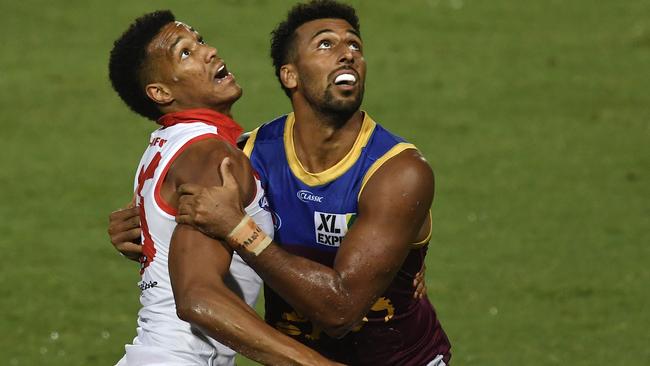 Joel Amartey (left) on debut for the Sydney Swans against Brisbane Lions.