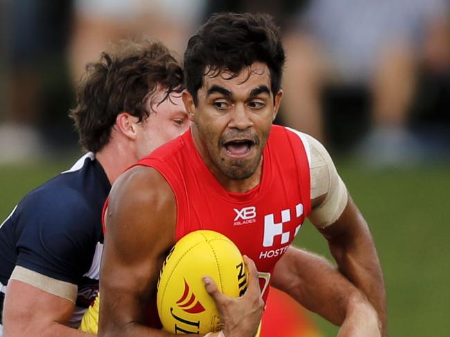 Jack Martin of Gold Coast Suns is tackled  during the AFL JLT Community Series match between the Gold Coast Suns and the Geelong Cats at Riverway Stadium in Townsville, Sunday, March 4, 2018. (AAP Image/Dave Acree) NO ARCHIVING, EDITORIAL USE ONLY