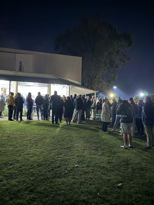 People waiting outside Mt Eliza Community Hall on Wednesday night.