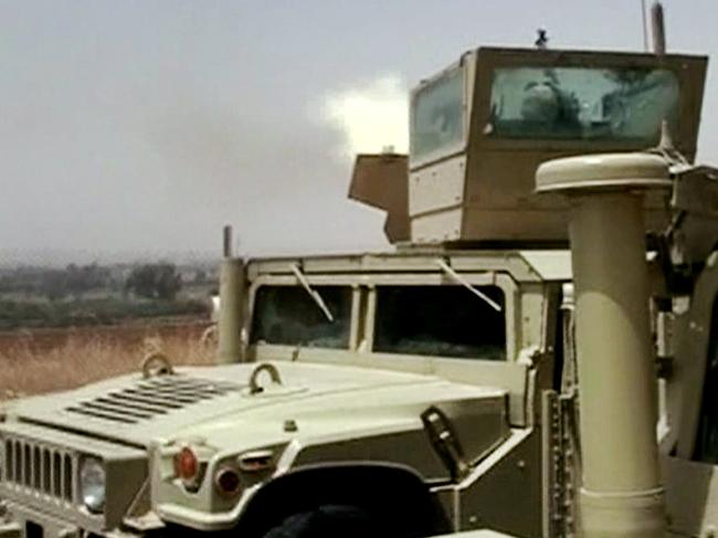 In this Monday, June 9, 2014 image taken from video obtained from the Iraqi Military, which has been authenticated based on its contents and other AP reporting, an Iraqi army tank fires towards militants during clashes in in the northern city of Mosul, Iraq. Insurgents on Tuesday pressed their efforts to seize effective control of Iraq’s second-largest city of Mosul on Tuesday after Iraqi security forces abandoned their posts and militants overran the provincial government headquarters and other key buildings, dealing a serious blow to Baghdad’s attempts to tame a widening insurgency in the country. (AP Photo/Iraqi Military via AP video)