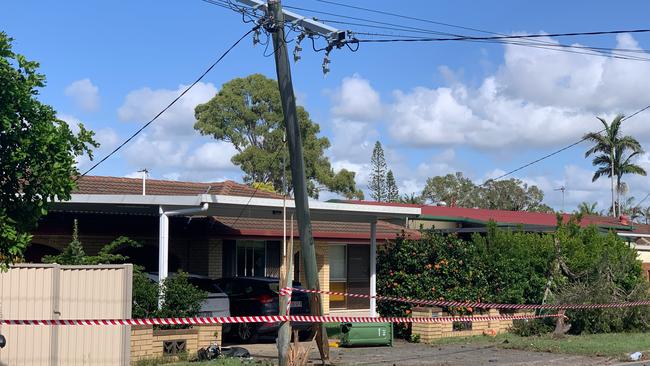 A car has careened through Bayview St, Hollywell snapping a power pole in half and smashing through three properties, two fences and a brick wall before colliding with a parked car. Picture: Kathleen Skene