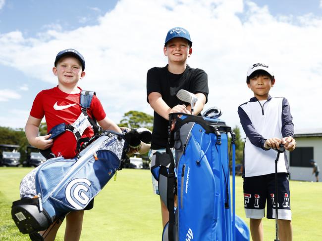 Darragh Sheard, 7, Ari Skrabal, 10, and Lewis Sun, 9, during a coaching clinic at the course in Moore Park. Picture: Jonathan Ng