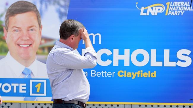 Queensland Opposition Leader Tim Nicholls walks past one of his signs as he visits Ascot State School in Ascot.  Picture: AAP Image/Tracey Nearmy