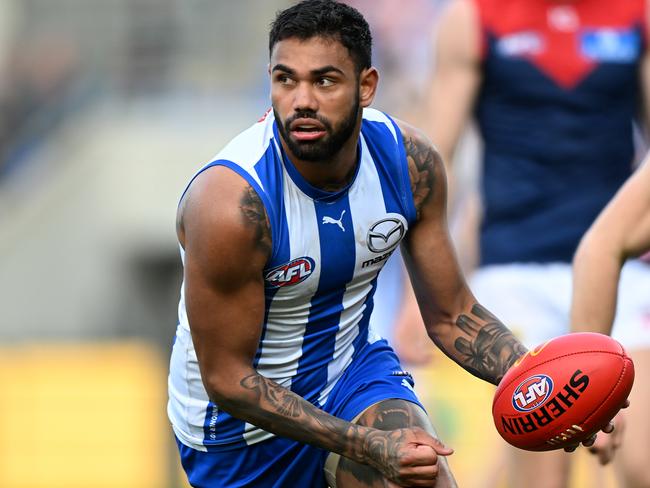 HOBART, AUSTRALIA - AUGUST 06: Tarryn Thomas of the Kangaroos runs the ball during the round 21 AFL match between North Melbourne Kangaroos and Melbourne Demons at Blundstone Arena, on August 06, 2023, in Hobart, Australia. (Photo by Steve Bell/Getty Images)