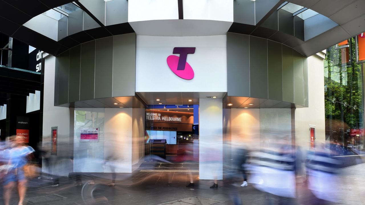 Pedestrians walk past a Telstra Corp. Discovery store in Melbourne, Australia, on Tuesday, Feb. 9, 2016. Telstra, Australia's biggest phone company, is scheduled to report half-year results on Feb. 18. Photographer: Carla Gottgens/Bloomberg