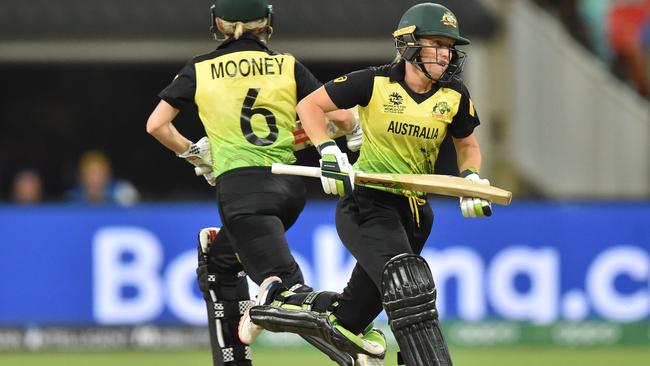 Australian cricketers Alyssa Healy (R) and Beth Mooney (L) make runs against India during the opening match of the women's Twenty20 World Cup at the Sydney Showground on February 21, 2020. Picture: PETER PARKS /AFP