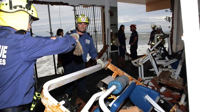 Fire &amp; Rescue crews cleaning up the mess inside the gym at Coogee SLSC. Picture: Craig Wilson