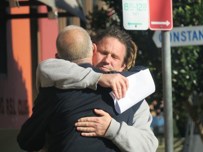 Jamie Joseph King, 47, of Mardi, hugs a supporter outside Wyong Local Court, where he pleaded guilty over a violent home invasion. Picture: NewsLocal