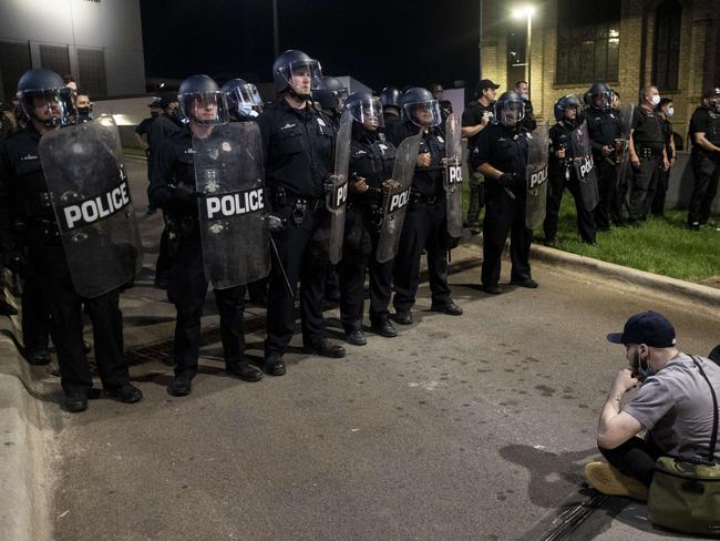 Protesters sit in front of a line of police officers in Detroit, Michigan. Picture: Getty