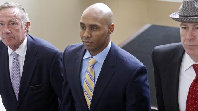 Mohamed Noor, centre, accompanied by his legal team, Peter Wold, left, and Tom Plunkett, right, arrive at the Hennepin County Government Centre for a hearing in Minneapolis. Picture: AP