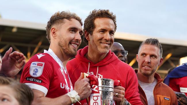 Ryan Reynolds and goalscorer Sam Smith pose with the League One trophy after Wrexham defeated Charlton Athletic to win promotion to the Championship. Picture: Getty Images