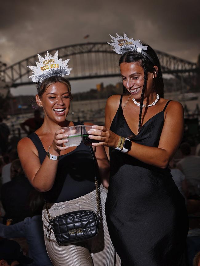 Jodi Tooke (left) and Emma Peto tick one item off the bucket list – celebrating the New Year in Sydney. Picture: Sam Ruttyn