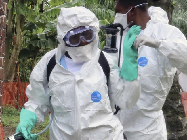 FILE - In this Thursday, May 31, 2018, file photo, Congolese health officials prepare to disinfect people and buildings at the general referral hospital in Mbandaka, Congo. At least four new cases of the Ebola virus have emerged in Congo's northeast, just a week after an outbreak in the northwest was declared over, the country's health ministry said Wednesday. Aug 1, 2018. There was no indication the two outbreaks, separated by more than 2,500 kilometers (1,553 miles), are related, Health Minister Dr. Oly Ilunga Kalenga said in a statement. (AP Photo/John Bompengo, File)