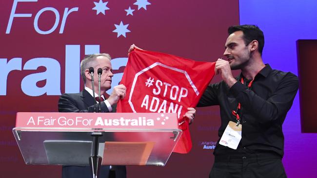 Bill Shorten is confronted by an Adani protestor. Picture: AAP 