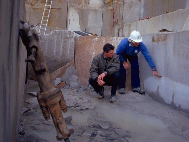 Greg Cook (squatting) selecting the blocks of sandstone for St Mary's Cathedral spires.