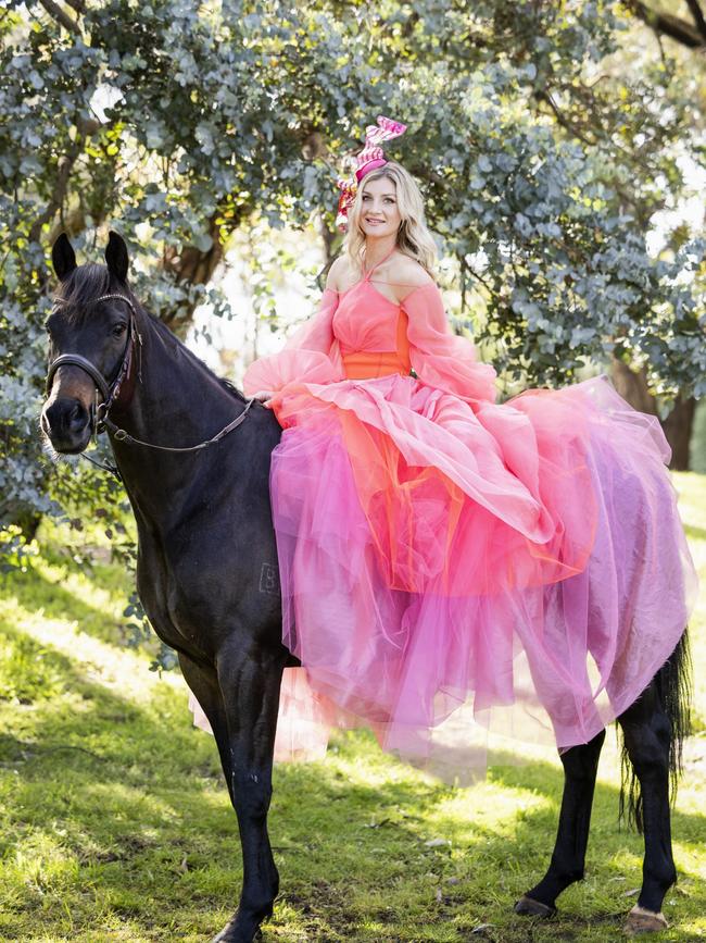 The young jockey also enjoys dressing up at the races, when she’s not riding. Picture: Nicole Cleary