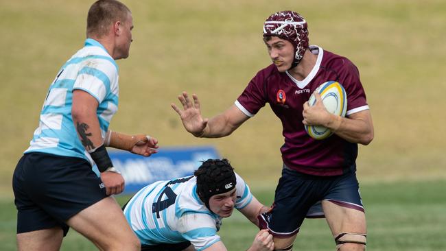 Queensland’s Jack Henry tackled by Max Roach. Picture: Julian Andrews
