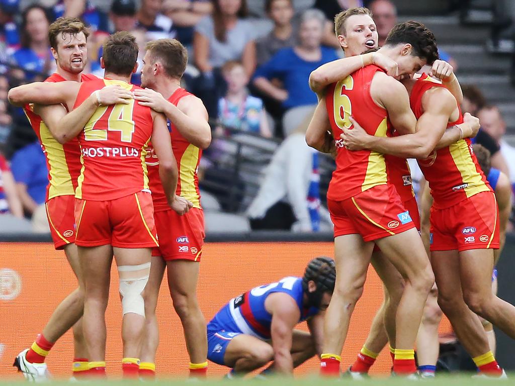 MELBOURNE, AUSTRALIA - APRIL 07: Gold Coast players celebrates the win on the final siren during the round three AFL match between the Western Bulldogs and the Gold Coast Suns at Marvel Stadium on April 07, 2019 in Melbourne, Australia. (Photo by Michael Dodge/Getty Images)