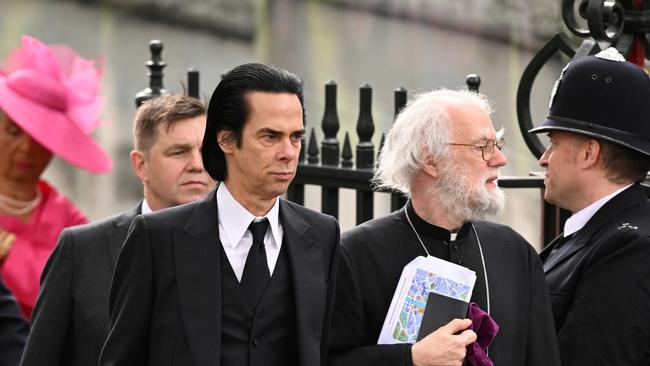 Nick Cave and Rowan Williams arrive at Westminster Abbey. Picture: Jeff Spicer