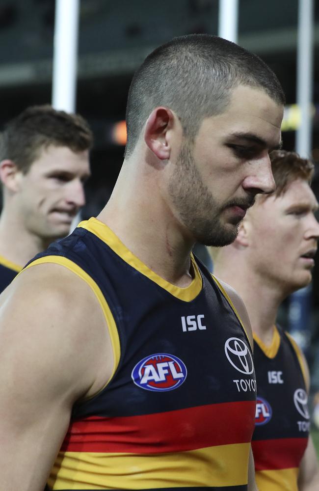 Adelaide skipper Taylor Walker leads his players off the field last night. Picture: SARAH REED