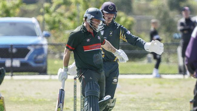 Clyde keeper James North (back) and Tooradin batter Russell Lehman. Picture: Valeriu Campan