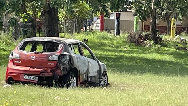 A car burnt out in a park on Keith Moses Crescent, West Kempsey. Picture: Janine Watson