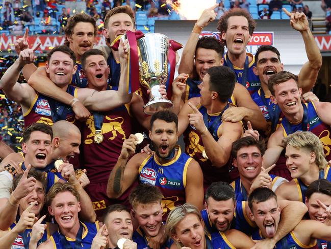 Brisbane Lions players celebrate with the premiership cup after winning the AFL Grand Final after defeating the Sydney Swans at the MCG. Picture Lachie Millard