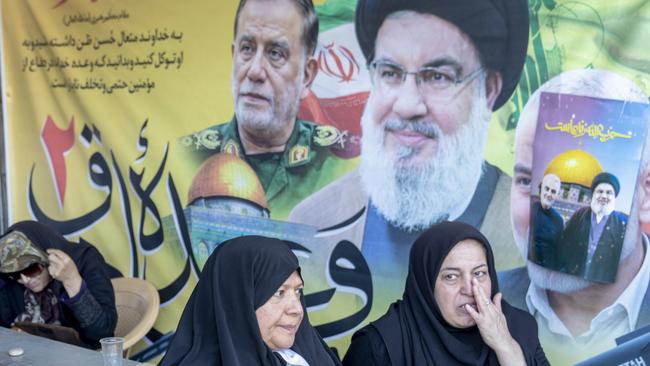 Tehran, Iran - October 13: Iranians rest next to posters of the dead including Hassan Nasrallah after Friday prayers on October 13, 2013 in Tehran, Iran. Protesters supporting Iran's military position against Israel take to the streets of Tehran after Friday prayers at the Imam Khomeini Grand Mosalla mosque. The Leader of the Islamic Revolution Ayatollah Seyyed Ali Khamenei delivered a public sermon after a commemoration ceremony for the leader of Hezbollah who was killed in an Israeli airstrike in Beirut. (Photo by Majid Saeedi/Getty Images)