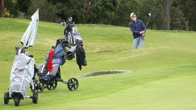 Wayne Banks plays from a bunker on the ninth hole at Ringwood Golf Course after coronavirus restrictions were eased to allow play to resume in Victoria. Picture: Hamish Blair