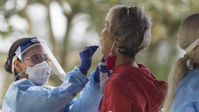 A woman takes a Covid test at the testing facility on the Esplanade. Picture: Brian Cassey