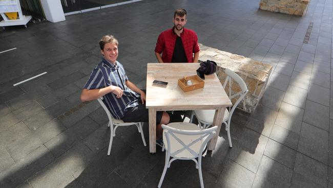 Beach Cafe customers Adrian David from Benowa and Alexis Michel from Surfers Paradise noticed how quiet it’s been. Picture: Glenn Hampson