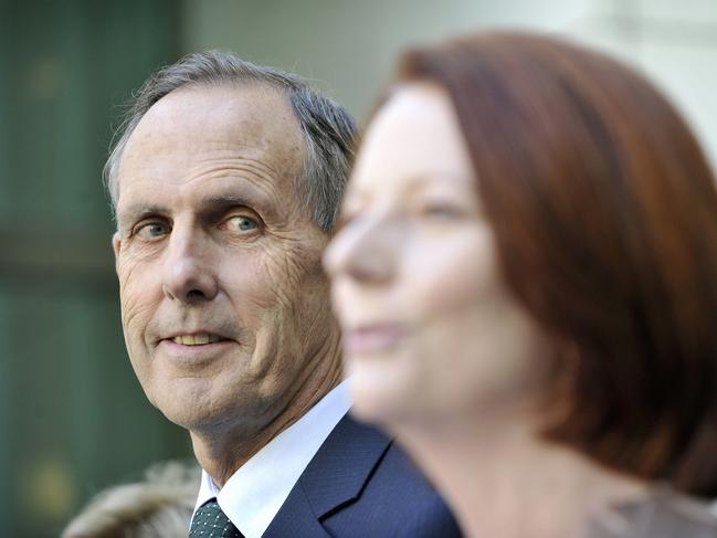 Greens leader Bob Brown listens to prime minister Julia Gillard announce the carbon tax. Picture: Getty