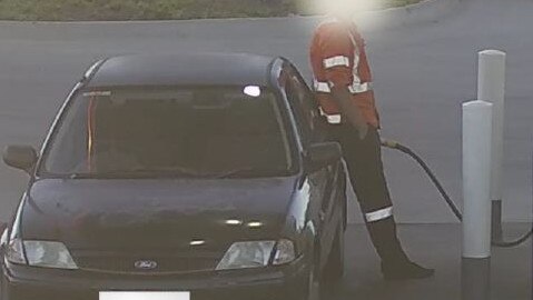 A man casually stands filling up his Ford car in January 2021 at Park Holme. Picture: SA Police