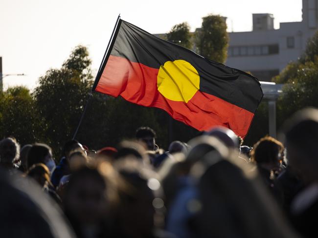 PERTH, AUSTRALIA - OCTOBER 31: The Aboriginal flag is held on October 31, 2022 in Perth, Australia. Cassius Turvey, 15, died in a Perth hospital last Sunday after he was violently assaulted in Middle Swan. Turvey was walking in the area with friends when he was assaulted. His death has triggered a wave of outrage across Australia, with many vigils and memorials taking place in several cities demanding justice. (Photo by Matt Jelonek/Getty Images)