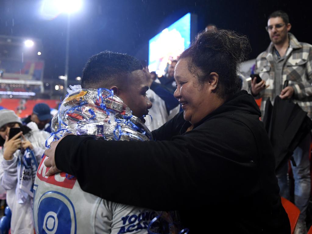 Lipoi Hopoi celebrates with family after his NRL debut. Picture: NRL Images