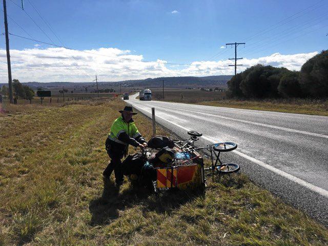 COLLAPSE: Warwick's Rubbish Rambler Leonard Monaghan has taken a fall on the Cunningham Highway this morning. Picture: Andrew Gale