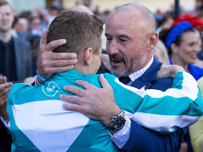 Glen Boss congratulates James McDonald on his Cox Plate victory aboard Hong Kong galloper Romantic Warrior. Picture: Mark Stewart