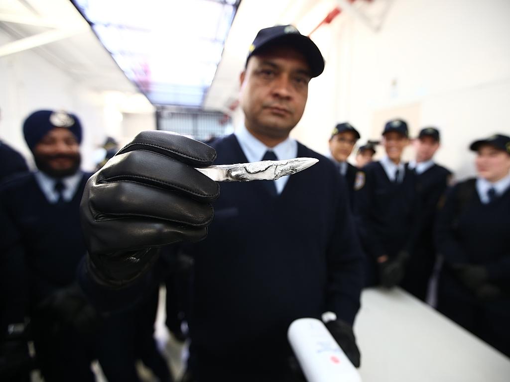 Correctional officer trainee Parmjit Singh holding a shiv which he found with an inmate’s belongings during a search training session at Long Bay Jail. Picture: Tim Hunter