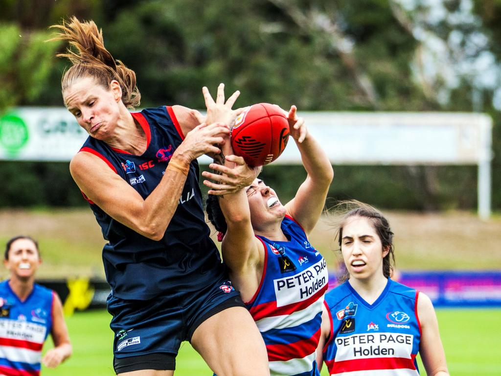 Norwood's Jo Hill in a fiercely contested mark with Central District's Abbie Sheer. Picture: Peter Argent