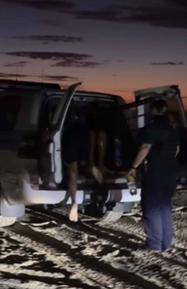The men that were rescued were placed into the back of a police vehicle. Photo: @nicka35 Instagram
