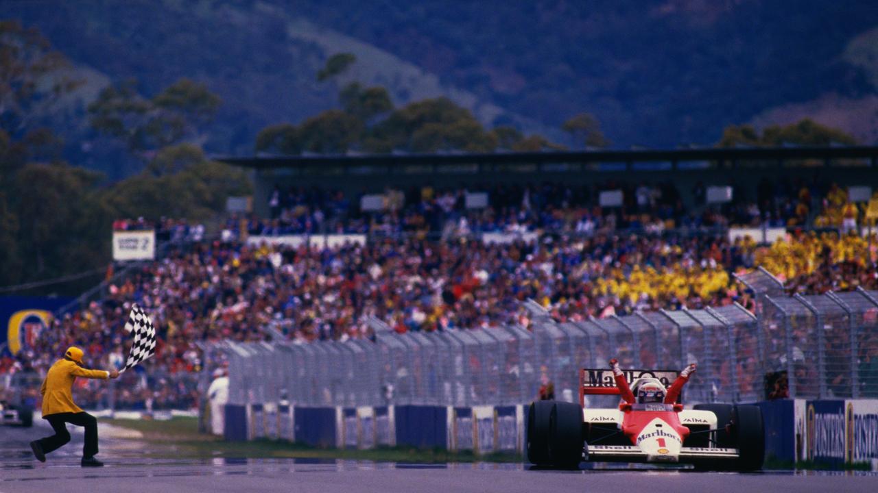 Alain Prost takes the chequered flag to win the 1986 Australian Grand Prix. Photo by Tony Feder.