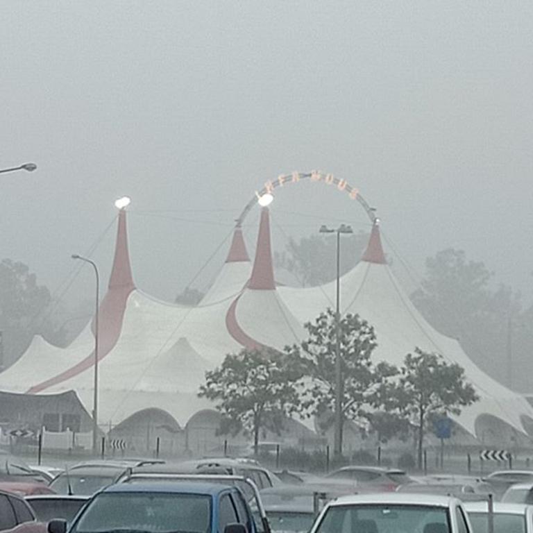 The Infamous tent at Westfield Helensvale viewed through the rain. Picture: Allan Laws.