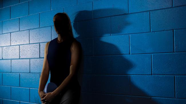 Generic, dark image of woman in AFL rooms. Original Pic Peter Wallis