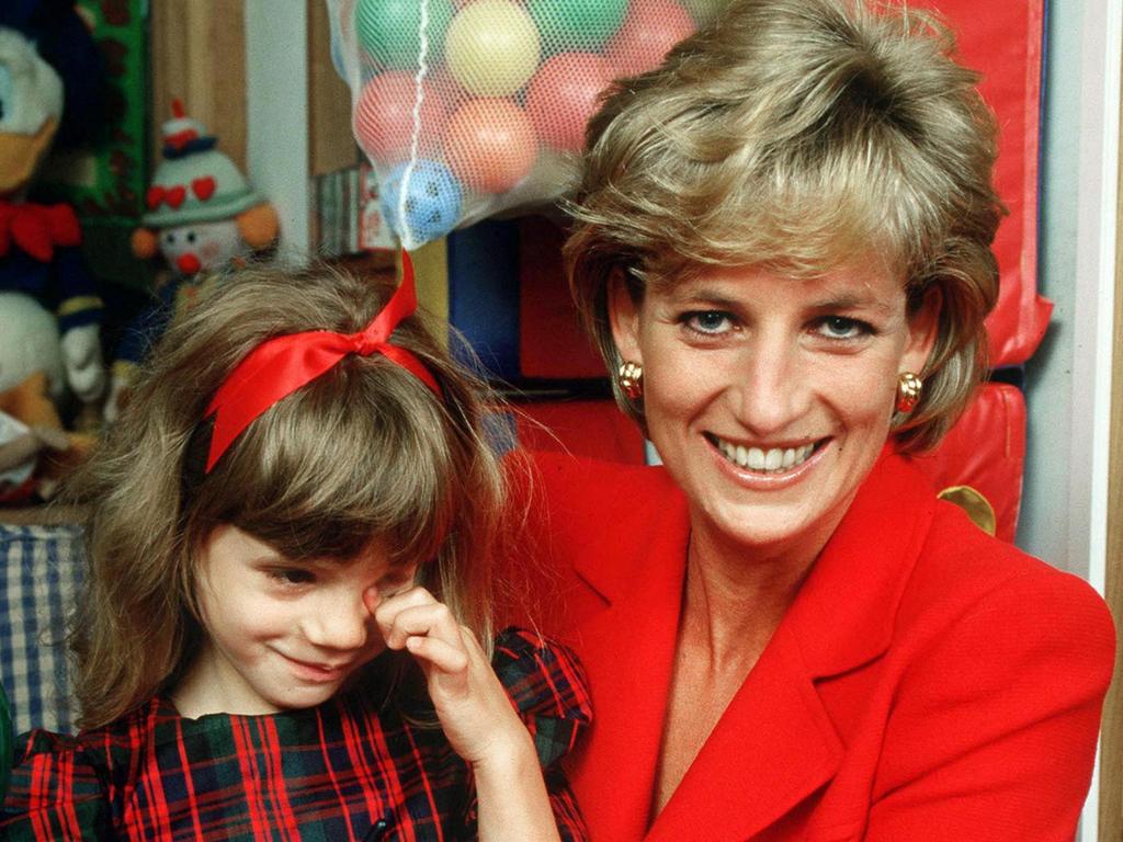 Princess Diana holding the child of an HIV patient at the London Lighthouse, a centre for people affected by HIV and AIDS, in London, 1996. Picture: Getty Images