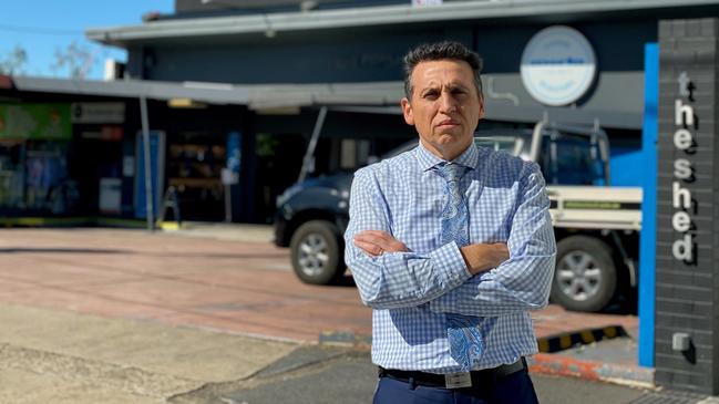 Councillor Peter Matic at the Paddington site, with the billboard. Residents want it removed.