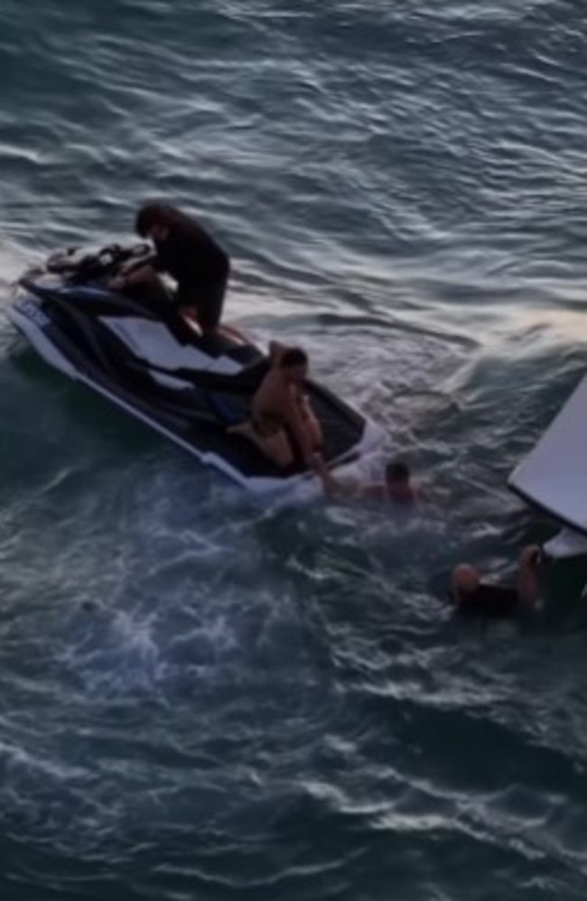The rescuers arrived by jet-ski to take the overboard men back to shore. Photo: @nicka35 Instagram