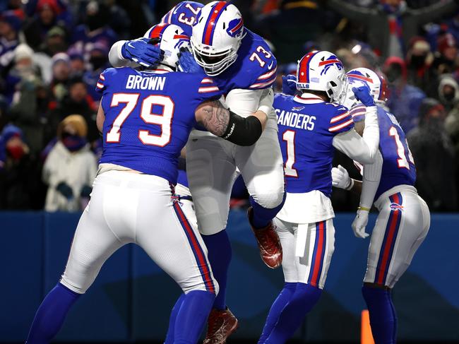 BUFFALO, NEW YORK - JANUARY 15: Spencer Brown #79 and Dion Dawkins #73 of the Buffalo Bills celebrate a touchdown against the New England Patriots during the fourth quarter in the AFC Wild Card playoff game at Highmark Stadium on January 15, 2022 in Buffalo, New York. (Photo by Timothy T Ludwig/Getty Images)