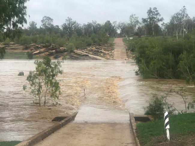 The Ted Cunningham Bridge has flooded near the Bowen River Hotel. Picture: Rachael Bowyer