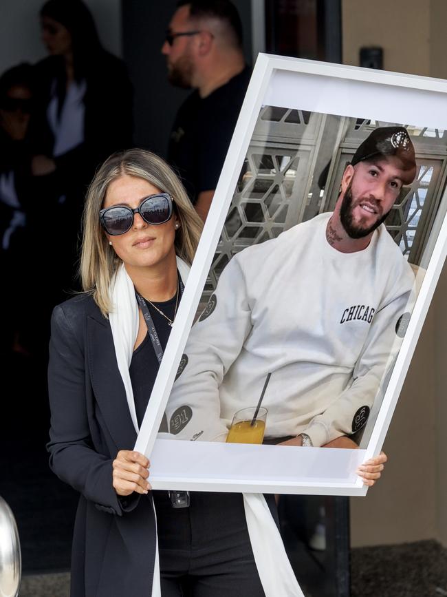 This woman held Abdulrahim’s photo up in front of the cameras, urging media to “take a photo for him”. Picture: NewsWire / David Geraghty